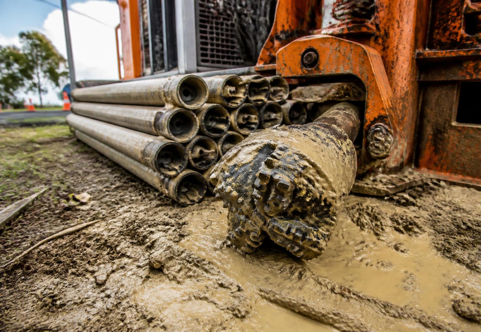 Drill rods and drill head beside a directional drilling rig
