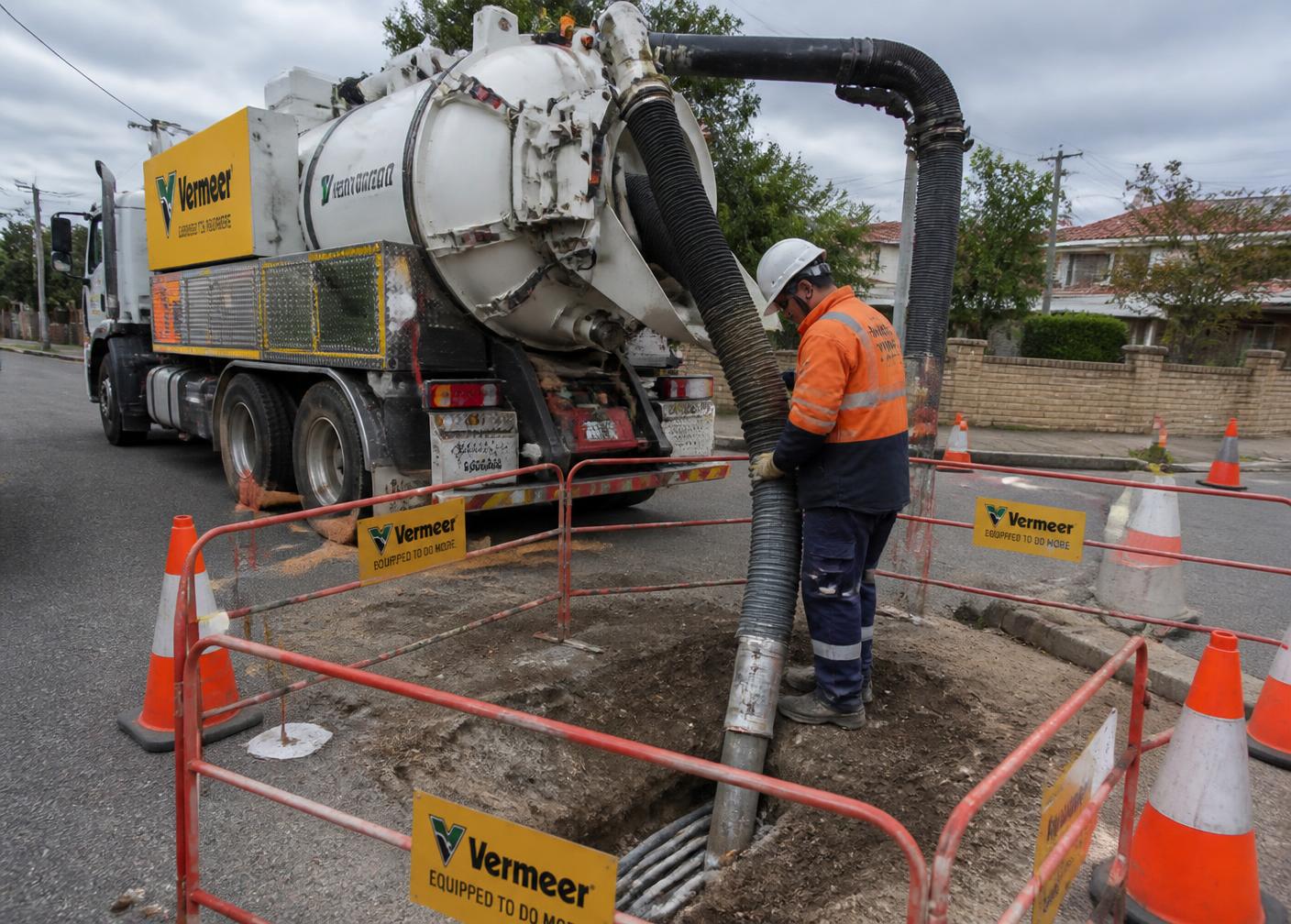 Vacuum excavation truck exposing underground utilities on an Australian street